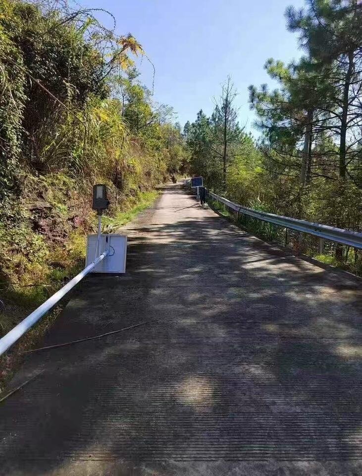 Mountain road: split kits being installed, pole on the ground before lifting